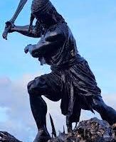 Mythlok - Bantong statue Statue of Bantong in traditional warrior attire, adorned with tribal patterns.