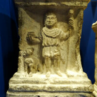 Mythlok - Sucellus carving Ancient carving of Sucellus etched into stone, showing him holding a long-handled hammer.