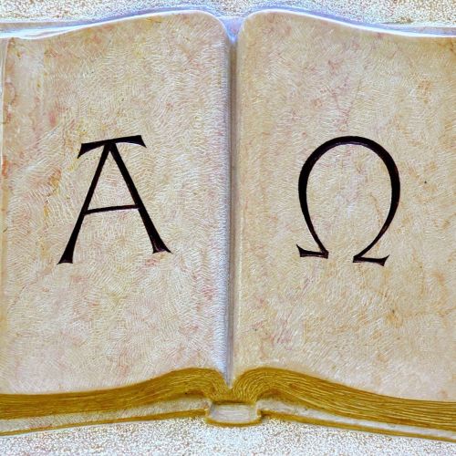 Alpha and Omega in a book representing Mythological Symbols