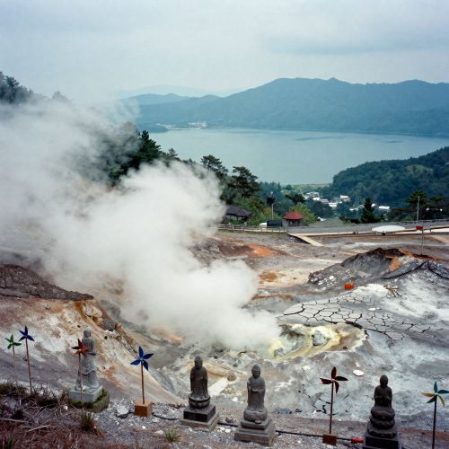 andscape of Mount Osore, Japan. Volcanic grey terrain with sulfur steam rising from cracked earth