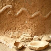 Ancient wall carving of the Dogon god Lebe